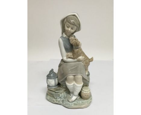 A Lladro figure of a girl with a dog.