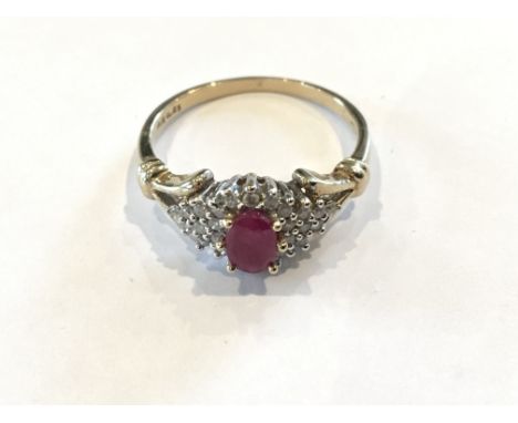 A 9ct Gold ladies ring set with a ruby flanked by diamonds.25 carat total diamond weight,