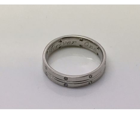 A modern design platinum wedding ring with inscription 'Forever One', inset with diamond chips, 0.16ct, colour E, VS2 clarity