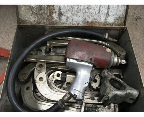 A box containing a collection of car maintaince tools together with an air driver and two axel stands