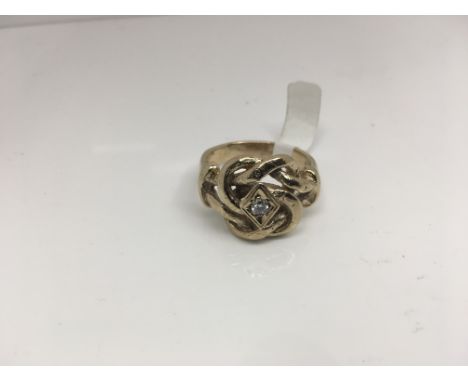 A diamond set knot ring in 9ct gold. Weight approx 15.92g Size approx 5