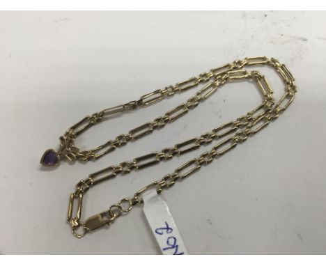 An amethyst and diamond necklace set in yellow gold. Weight approx 7.6g