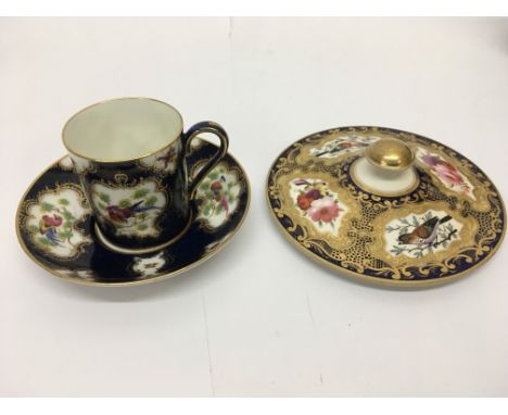 A Worcester cup and saucer and a hand painted lid with bird and giltwork decoration (2).