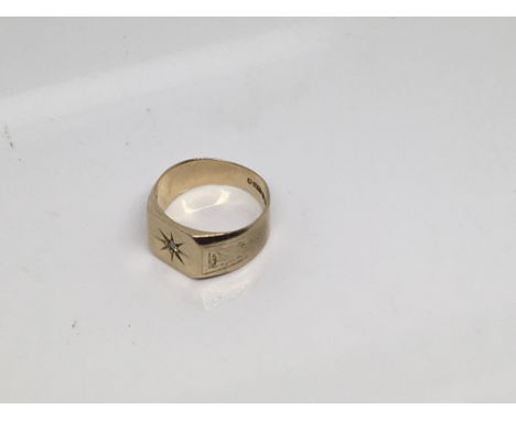 A gents 9 ct gold ring inset set with a single diamond 6 grams