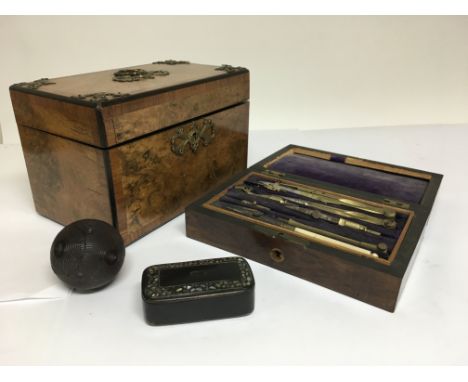 A tea caddy with brass motifs, cased writing set, snuff box, a carved ball etc.