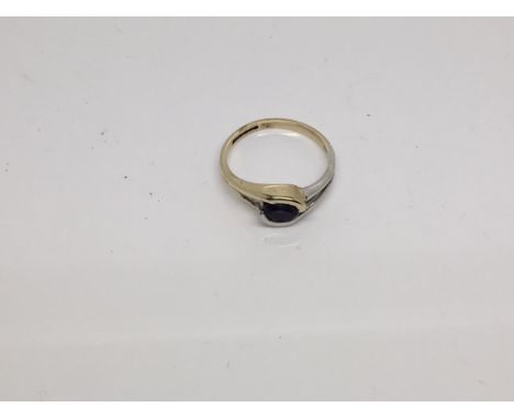 A modern design yellow & white gold amethyst ring. Size M.