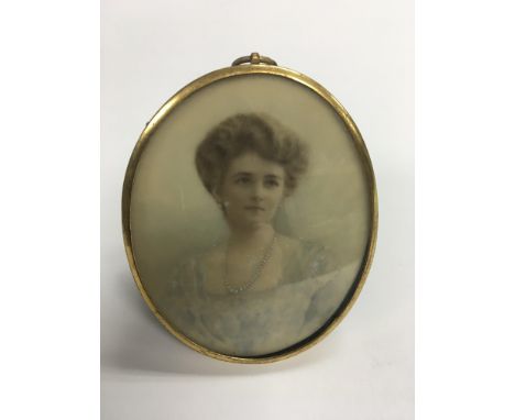 An oval portrait of a young lady painted on ivory. Size approx 9.5x7.5cm.