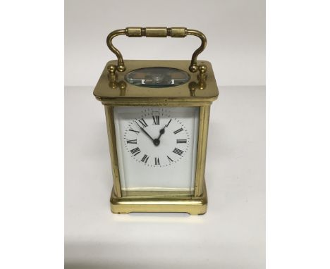 An French brass carriage clock the enamel dial with Roman numerals