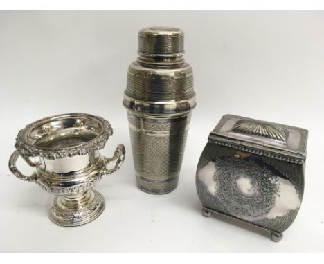 A silver plated cocktail shaker, tea caddy and urn