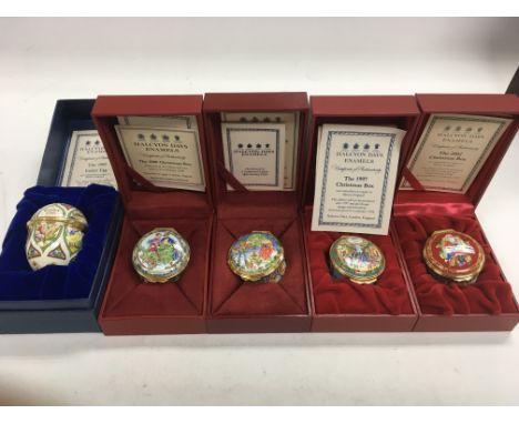 A collection of four ‘Halcyon Days’ enamel Christmas boxes (dated 2002, 1997, 2005 & 2006) with a 1995 Easter Egg.