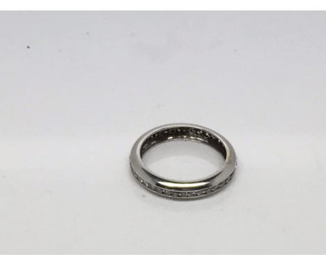 A white gold eternity ring set with single row of brilliant cut diamonds. Ring size M.