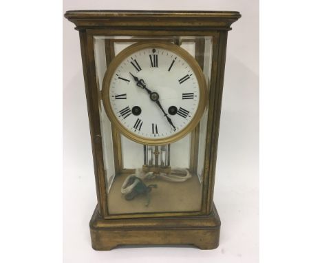 A four glass mantel clock the circular dial with Roman numerals and mercury pendulum