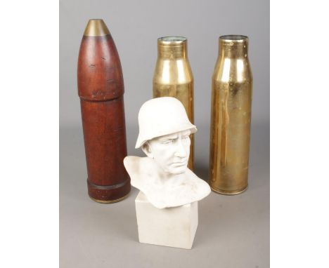 A collection of militaria to include pair of brass artillery shells, wooden artillery shell featuring broad arrow mark to bas