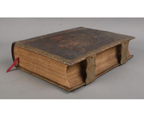 A leather bound Brown's Self Interpreting Family Bible. With gilt decoration to cover, brass mounts and colour plates. Adam &
