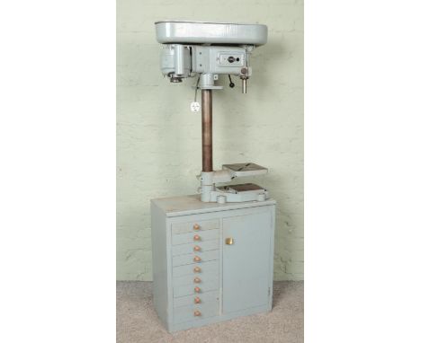 The 'Progress Ball Bearing drilling machine pillar drill, mounted on work-chest base, containing a collection of tools and dr