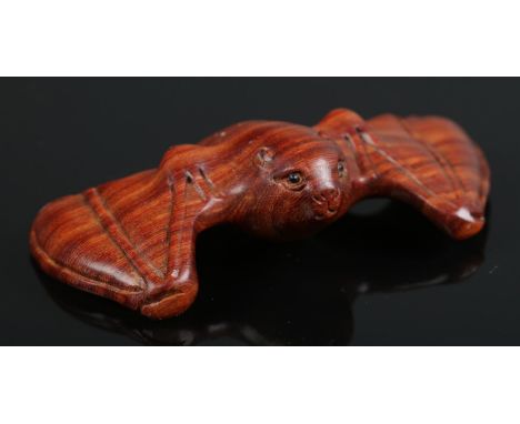 A hand carved hardwood netsuke of a bat  