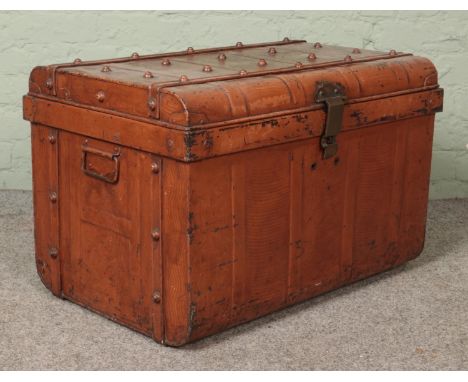 A vintage twin handled tin steamer trunk.  