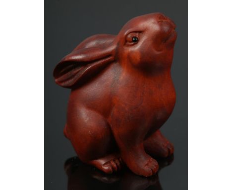 A hand carved hardwood netsuke of a rabbit  