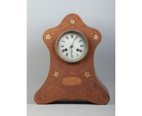 A mahogany cased mantle clock, with silvered dial featuring Roman Numeral markers and scrolled and floral Mother of Pearl inl