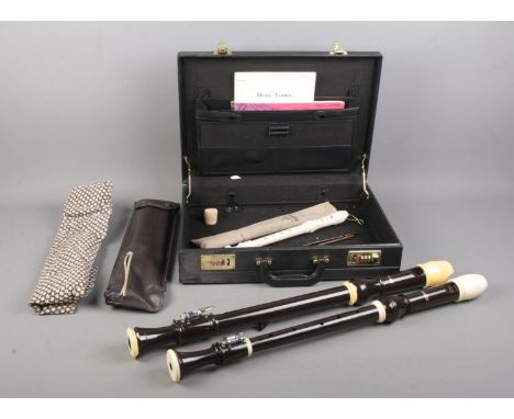 Two large Aulos recorders, together with a Yamaha Soprano Recorder in sleeve; all in hinged briefcase with sheet music.  