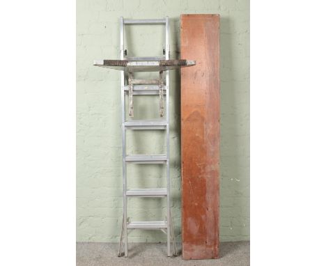 A folding wooden pasting table, together with a set of ABRU 'Step N Ladder' ladders and ladder platform/table.  