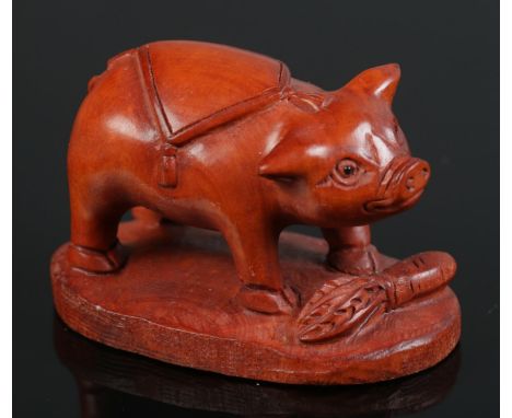 A hand carved hardwood netsuke of a pig  