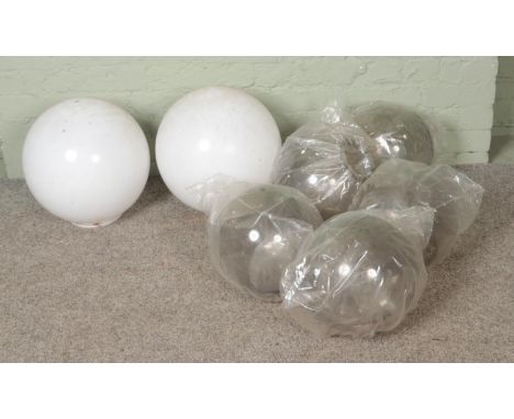 Seven plexiglass light shades in globe form to include two opaque white examples.  