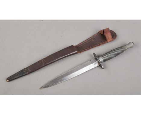 A Fairbairn-Sykes pattern Commando fighting knife, with cross guard stamped for William Rogers, Sheffield. In brown leather s