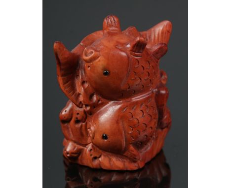 A hand carved hardwood netsuke of Koi fish  