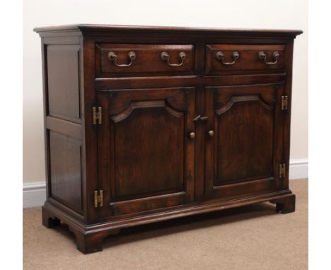 18th century style oak dresser, two drawers above two cupboard doors, shaped bracket supports, W113cm, H88cm, D48cm Condition
