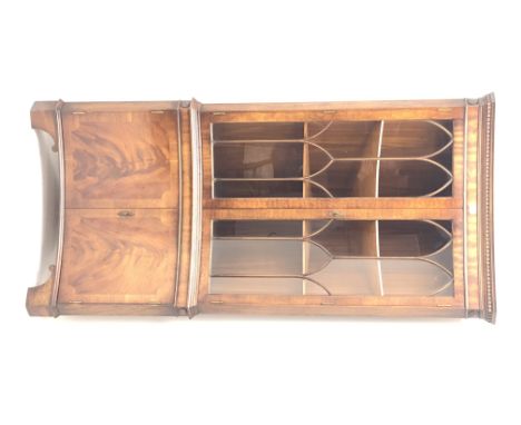 Reprodux Bevan Funnell mahogany concave corner display cabinet, projecting cornice, dentil frieze, two doors enclosing two sh