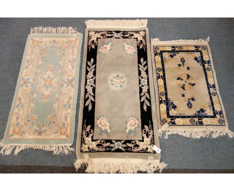 Chinese light blue ground rug, central floral medallion (140cm x 70cm) and two other similar rugs (3) Condition Report Click 