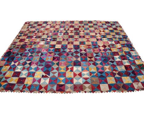 An Early 20th Century Silk Patch Work Bed Cover, comprising squares made up of four triangles each in two contrasting colours