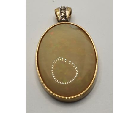 A 9ct gold opal and diamond pendant, chipped, length 43 mm. 