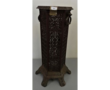 A cast iron hexagonal twin handled structure, each panel with pierced decoration, raised on feet, no lid or base, 70 x 30 cm.