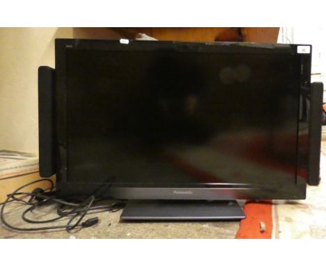 A Panasonic TX-L32E30B television with external speaker system, hand set. 