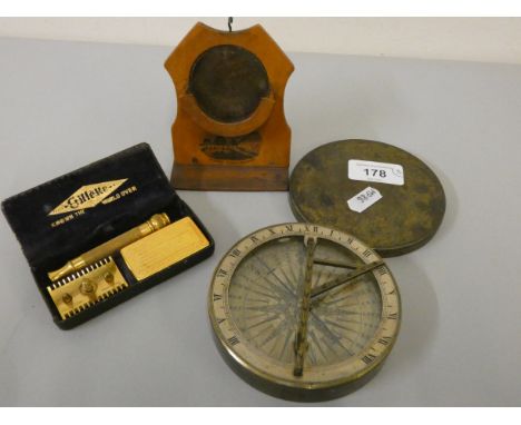 An 18th century style sundial/compass in brass mount, diameter 10.5 cm, an Edwardian Skegness souvenir watch holder and a Gil