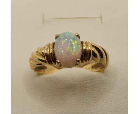 A gold and opal set ring, stamped 750, size N 1/2, size 3 gms. 