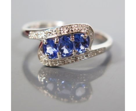 A 9 ct White Gold Tanzanite and Diamond Trilogy Ring, size O.5, 2.1 g