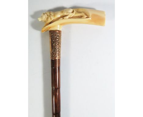 A Nineteenth Century Ivory Handled Walking Stick, the handle carved with a stalking lion