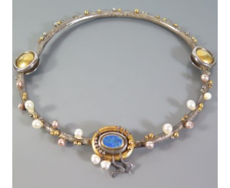 A Contemporary Hand Made Necklace with black opal and pearls on a white and yellow metal surround