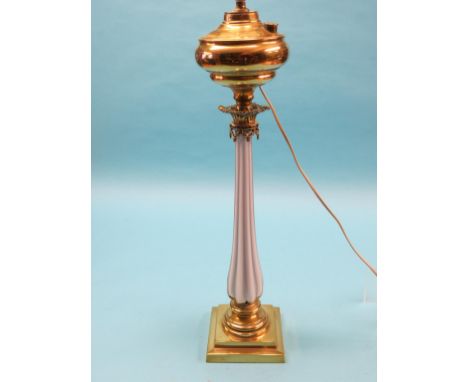 A large Victorian brass oil lamp, with unusual opaque glass stem, square base, with shade, converted to electric, 28in.