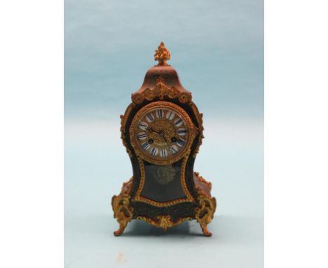 A 19th century boullework mantel clock, rococo shape with boulle and contra-boulle green tortoiseshell inlays, French movemen