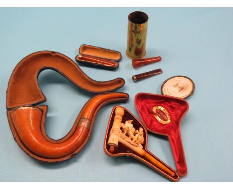 A large Meerschaum pipe, with engraved silver mount and amber mouthpiece, in original case, another, rare carved design of a 