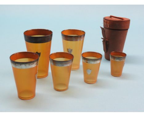 An unusual graduated set of six silver-mounted horn beakers, Edinburgh 1910, contained within original leather flask, tallest