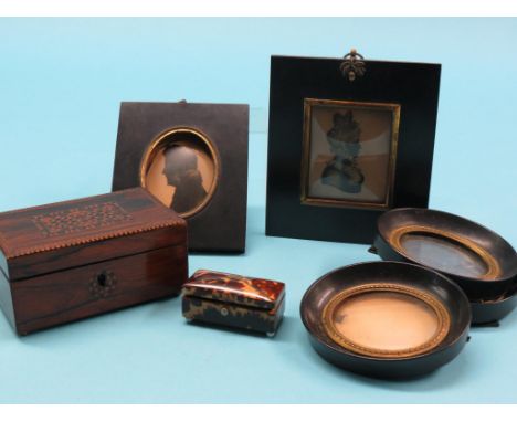 Two early Victorian silhouette portraits, male and female with bronzed detail, original frames, three further ebonised portra