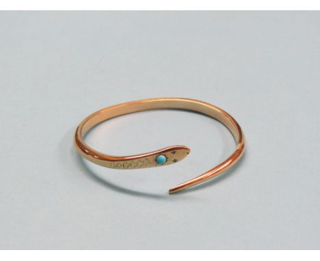 A yellow metal serpent bangle, set single turquoise and two clear stone chips, 38.9 grams gross total