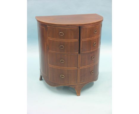 A George III inlaid mahogany commode, semi-eliptical with hinged top, simulated drawer-fronts, hinged folding seat enclosed, 