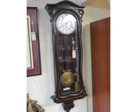 A Vienna-type wall clock, enamelled dial with timepiece movement, architectural case, with key, pendulum and weight, 40in.