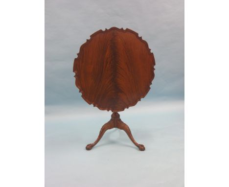 A Chippendale-style mahogany tilt-top centre table, flame-veneered top with pie-crust border and 'bird-cage' mechanism tripod